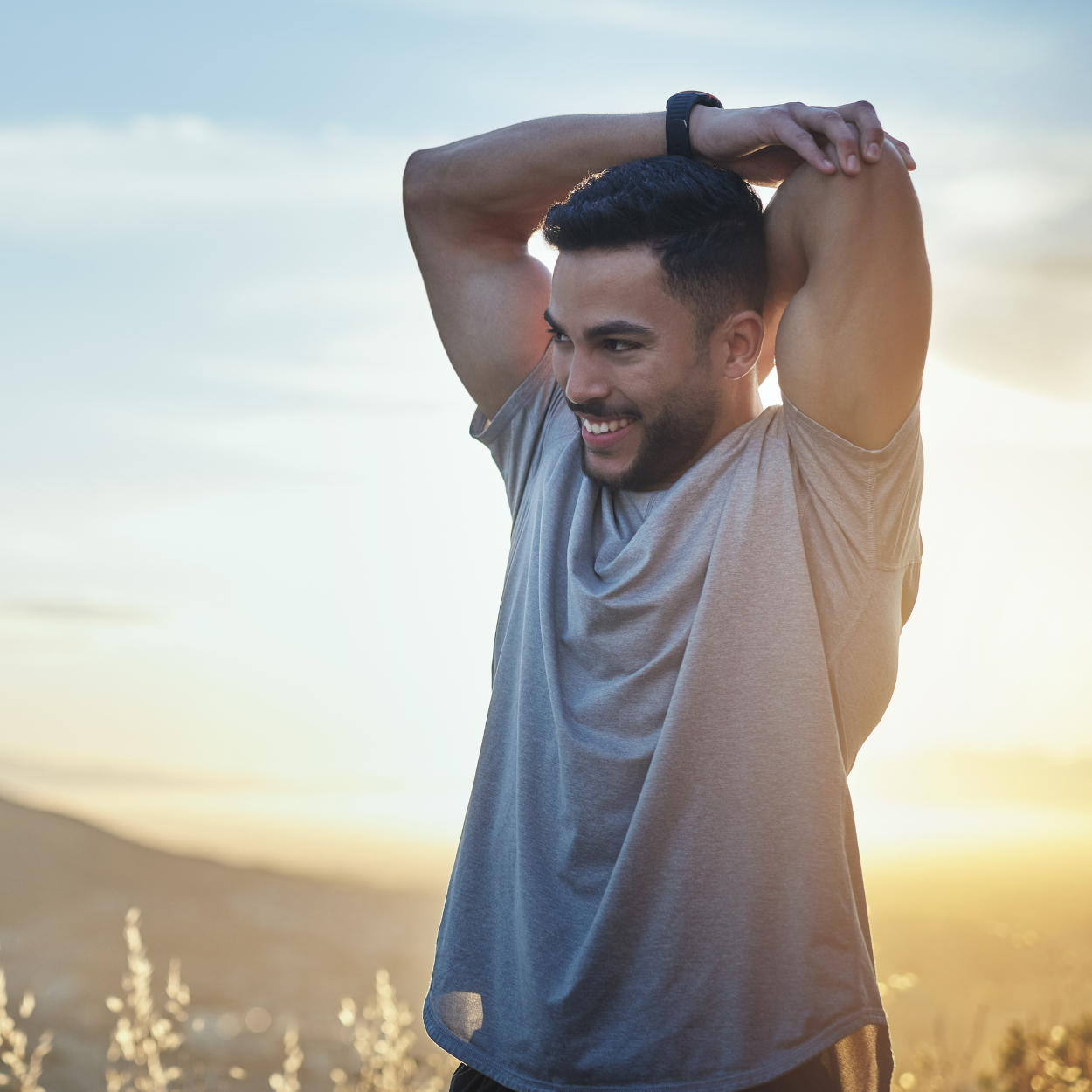Person stretching outdoors at sunset, embodying energy, recovery, and holistic wellness supported by IV Vitamin Infusions for hydration, immunity, and performance.
