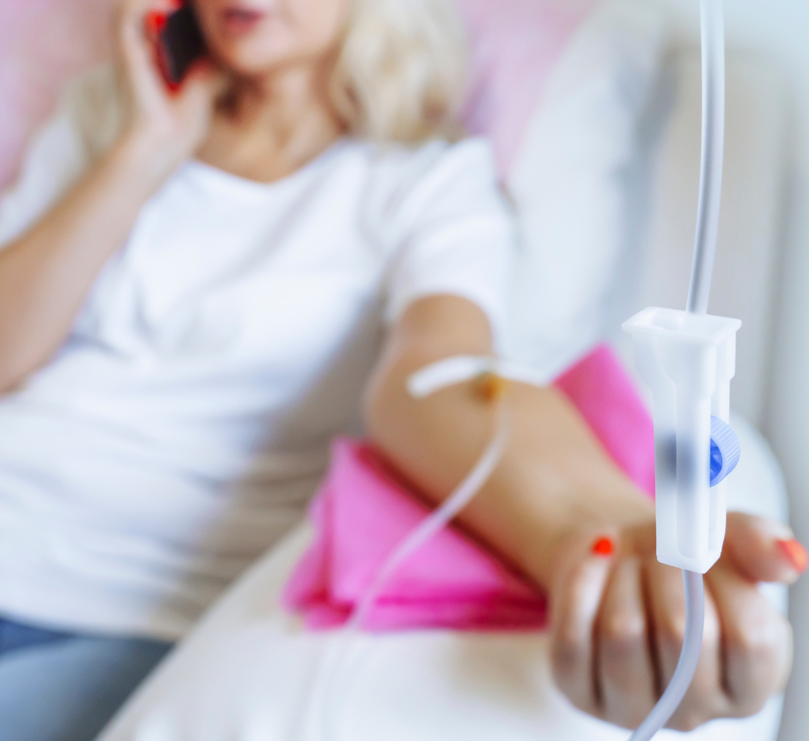 Close-up of IV therapy in progress with a relaxed patient in the background—representing ketamine infusions, and vitamin therapy at Mind Rejuvenation, Tulsa’s trusted wellness clinic.