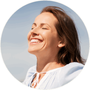 Peaceful woman in light blue blouse under a clear sky, representing rapid relief and emotional clarity from Ketamine IV Therapy for treatment-resistant depression, anxiety, and PTSD.